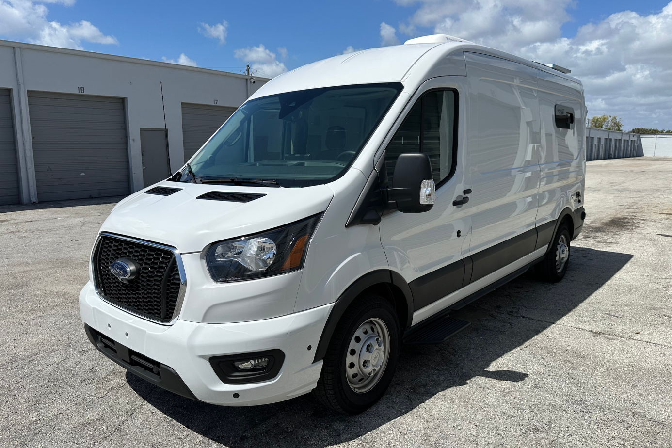Ford Transit camper van conversion Florida white van exterior front left side headlight and windows