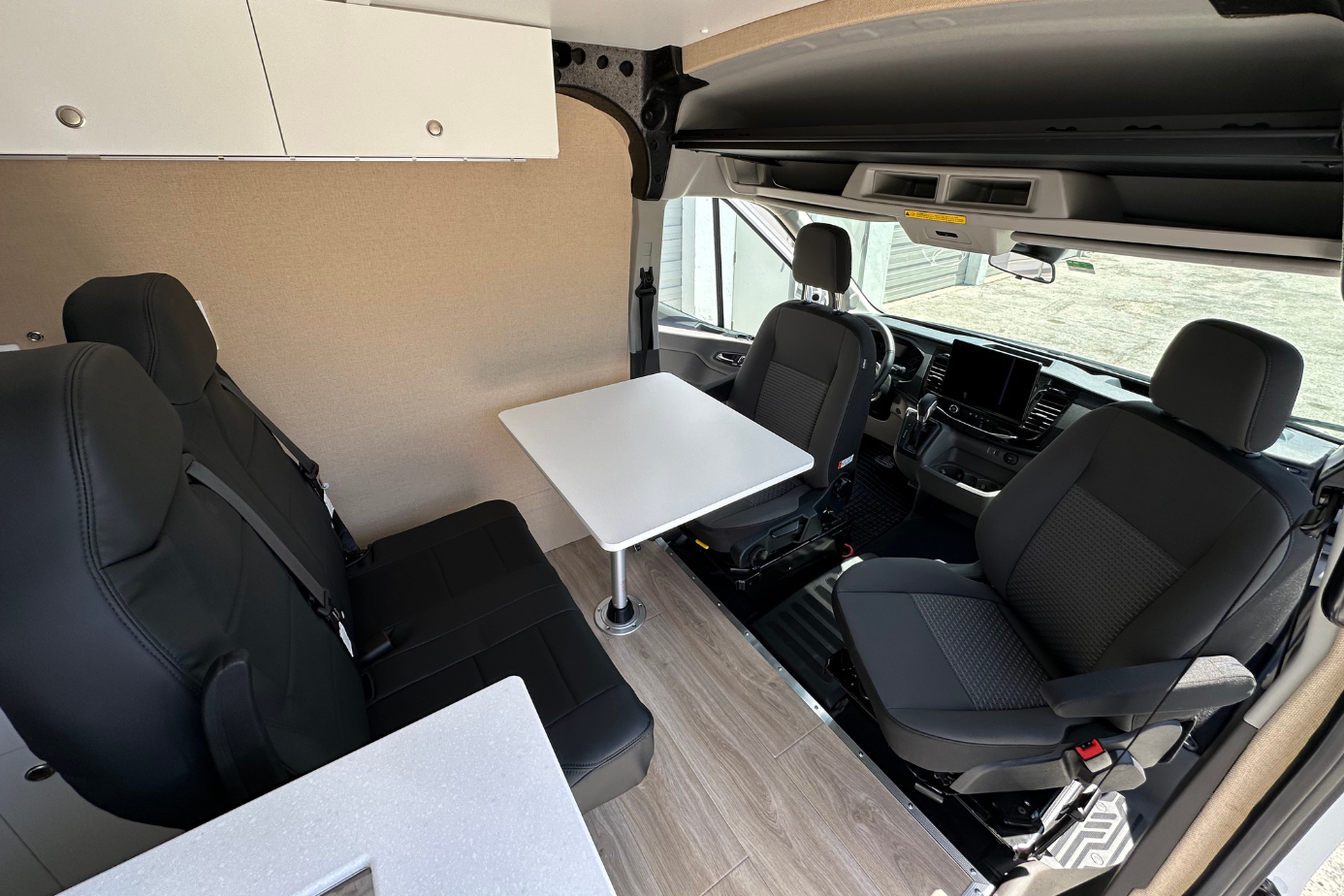 Custom Ford Transit camper van conversion Florida with swivel driver and passenger seats and foldable rear passenger seating